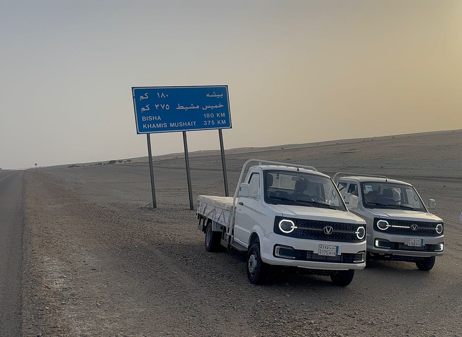 Two loaded Victory 2-Ton Diesel trucks on a desert highway during the 3,000 km test