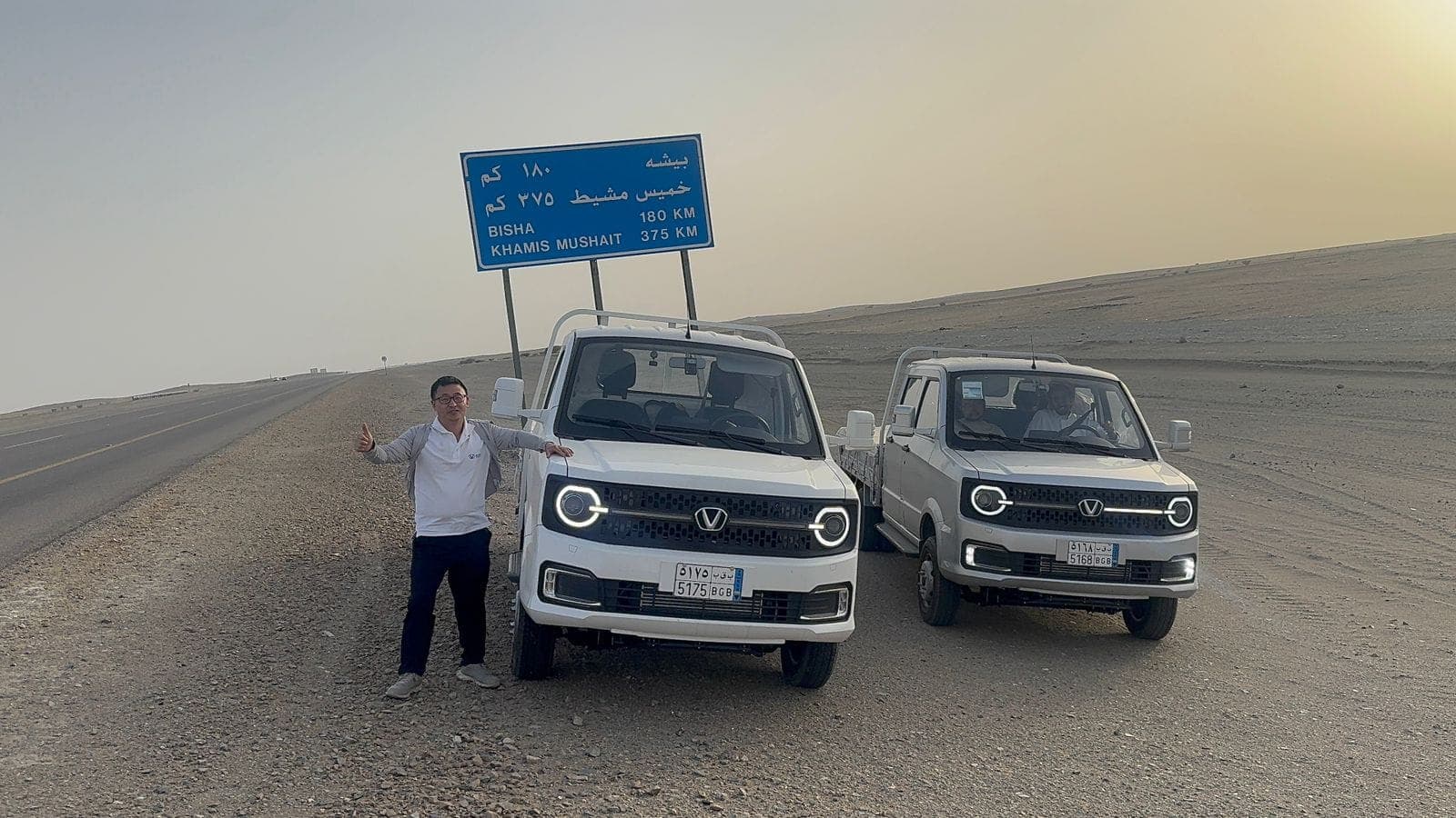 The Victory engineering team beside the Abha road sign during the endurance journey